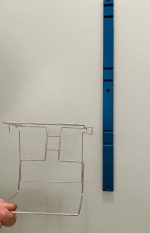 Glove box holder rail attached to the wall with the holder beside